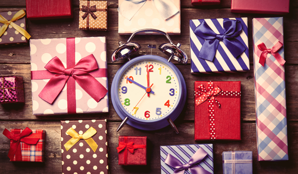table top cover with wrapped presents with an alarm clock in the center