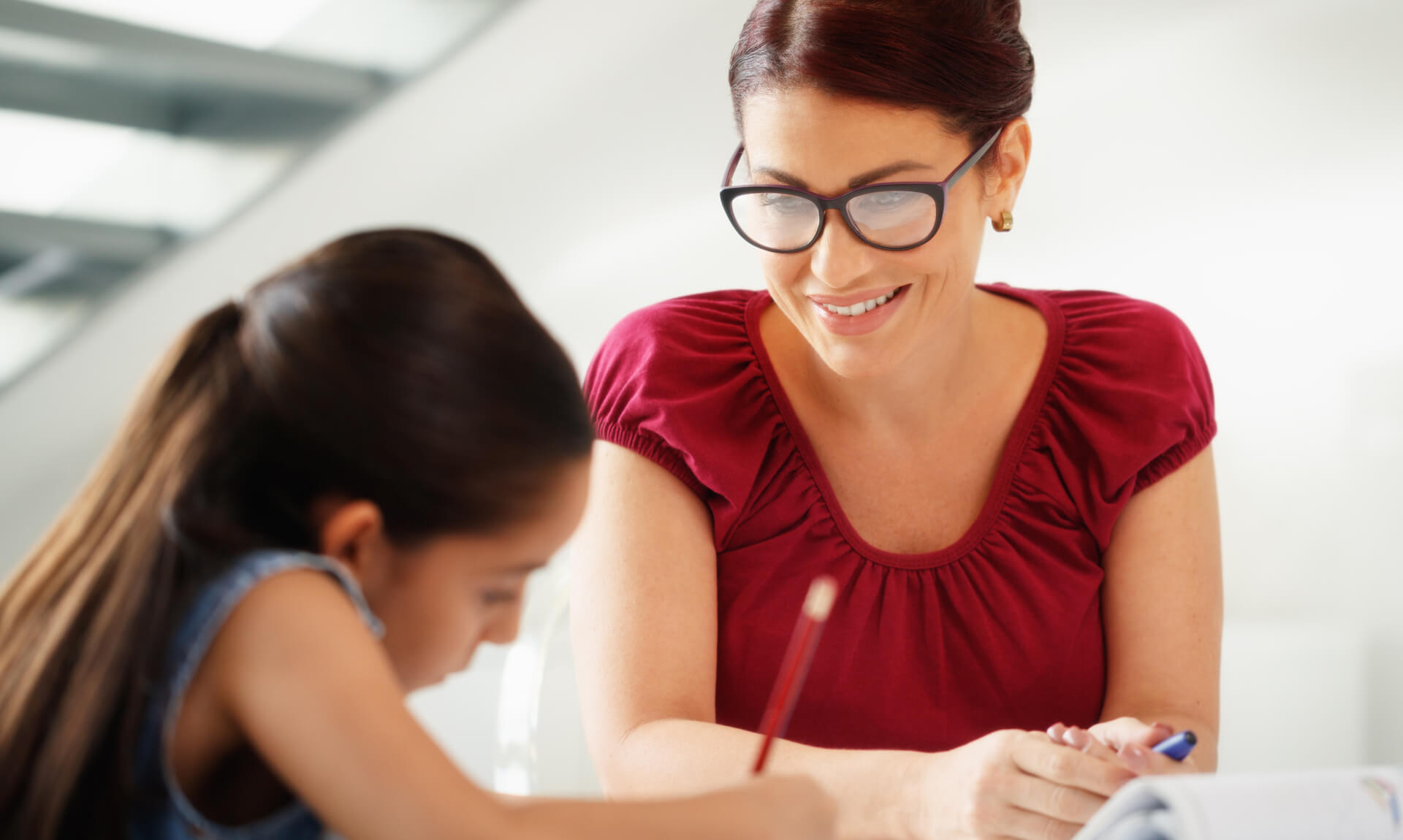 Therapist works with child at table.