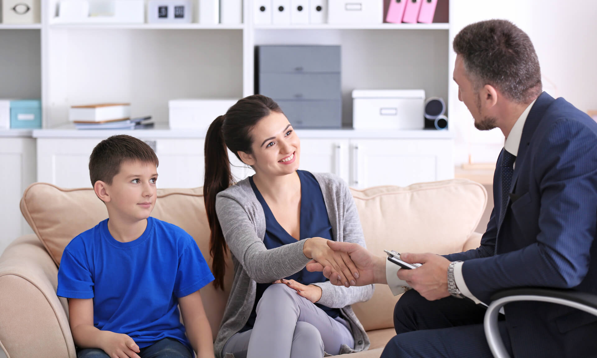 Young woman with son during meeting at school.