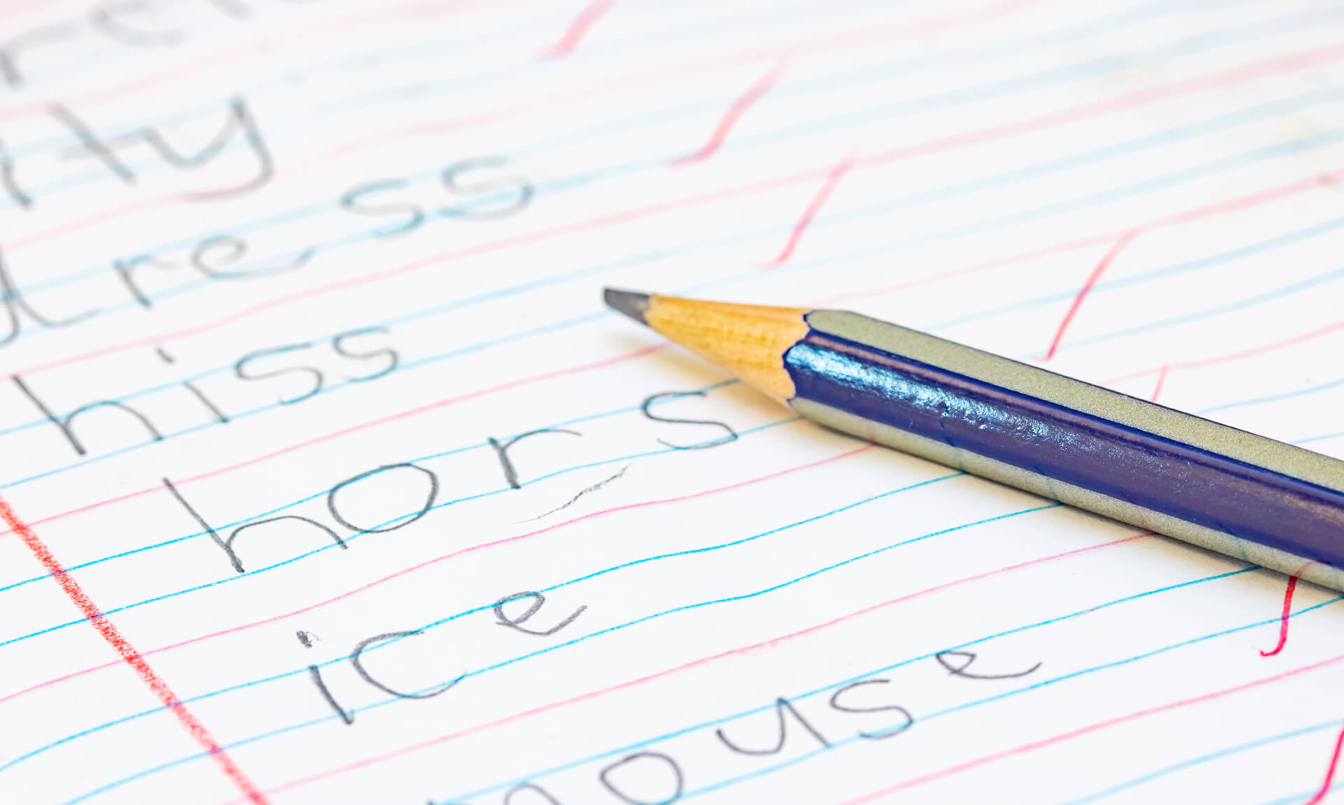 Close-up of pencil and spelling assignment