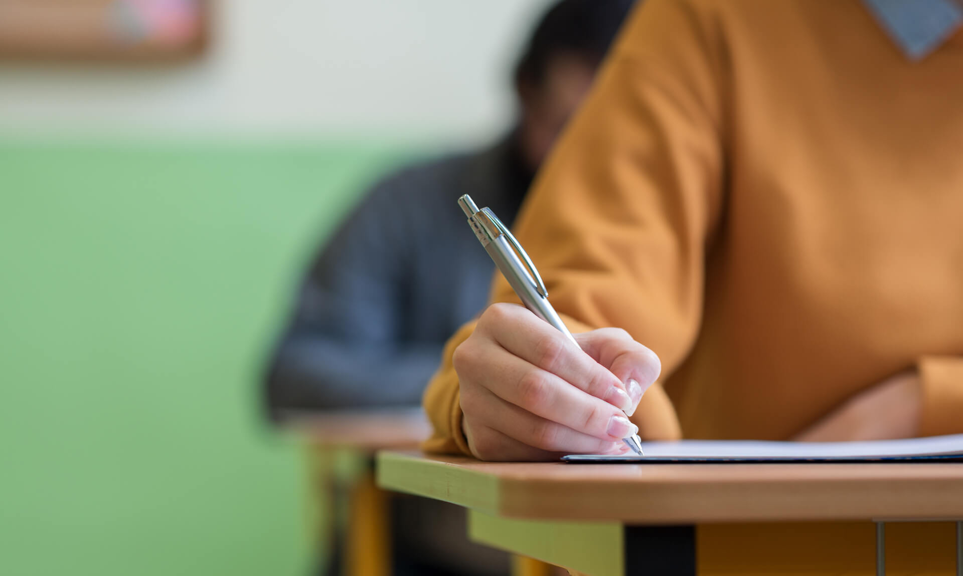 students taking exam in classroom