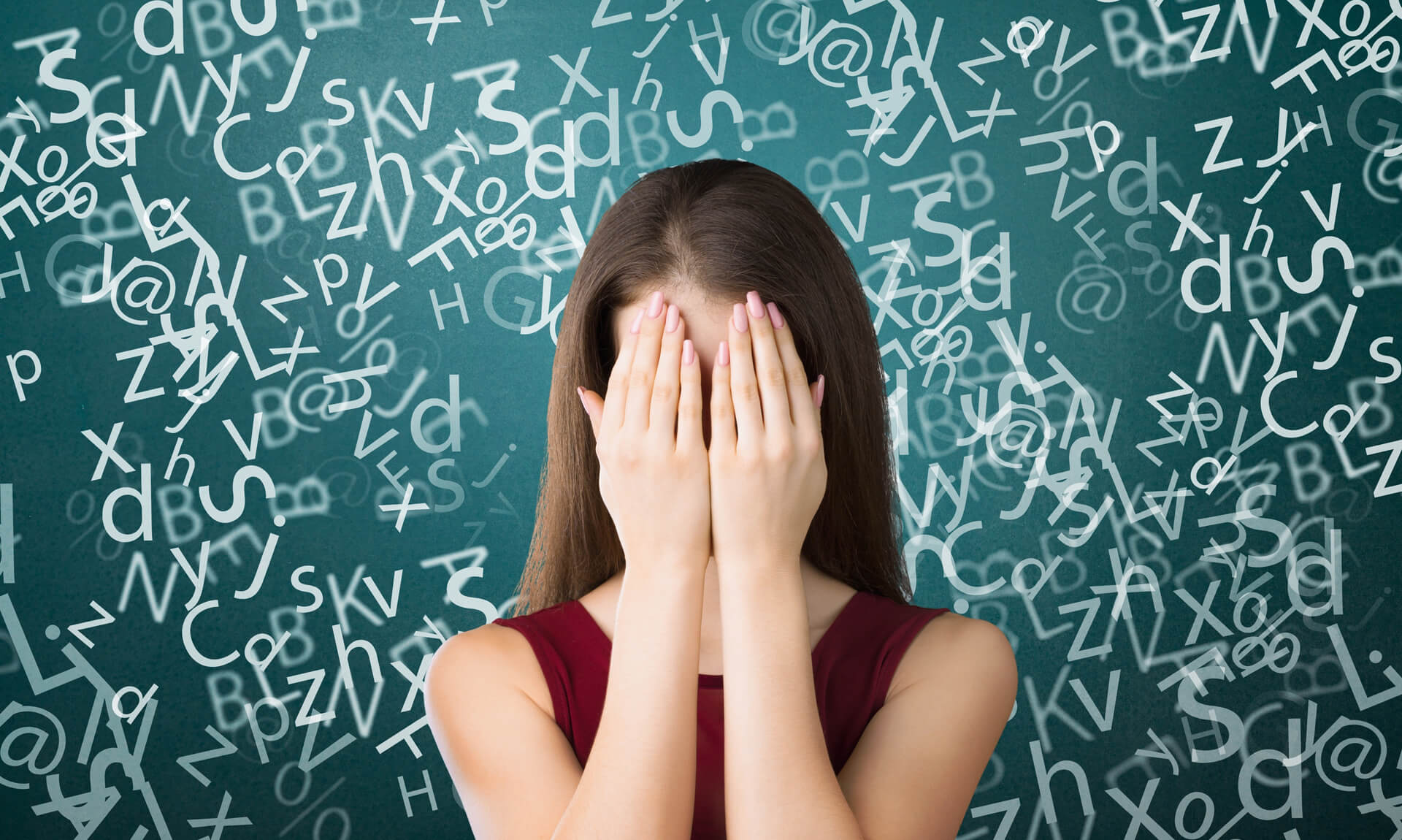 Student covers her face while surrounded by floating letters and symbols, illustrating the challenges of dyslexia and reading difficulties.