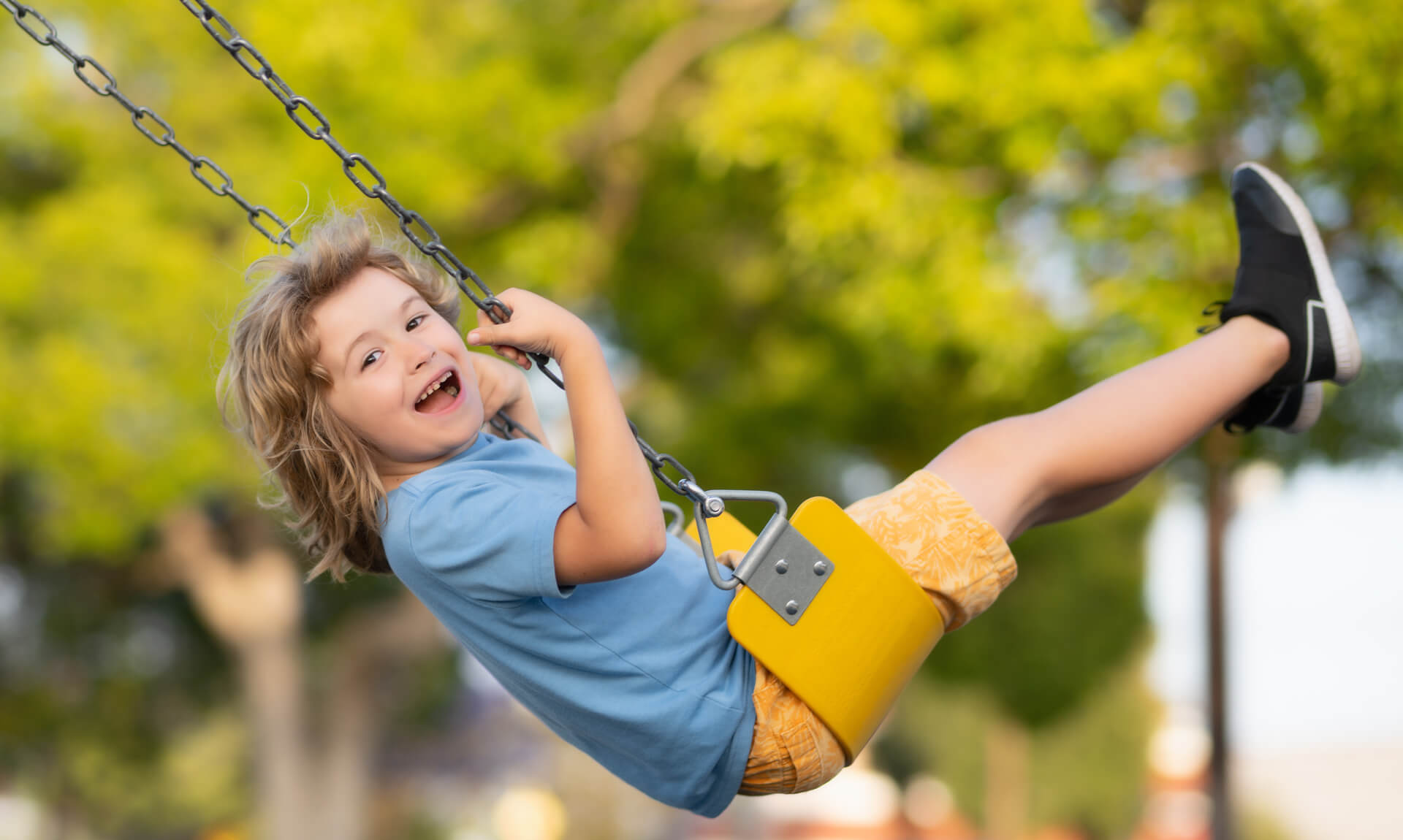 child smiles on a swing
